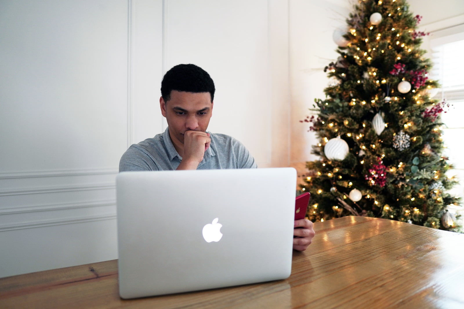 man in gray crew neck shirt sitting in front of silver macbook